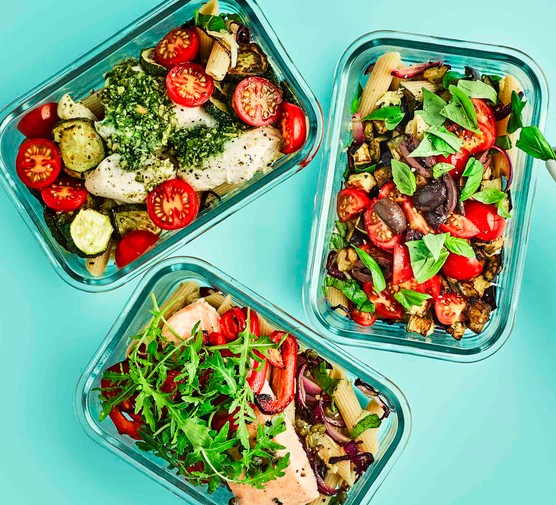 Meal prep containers with various healthy foods